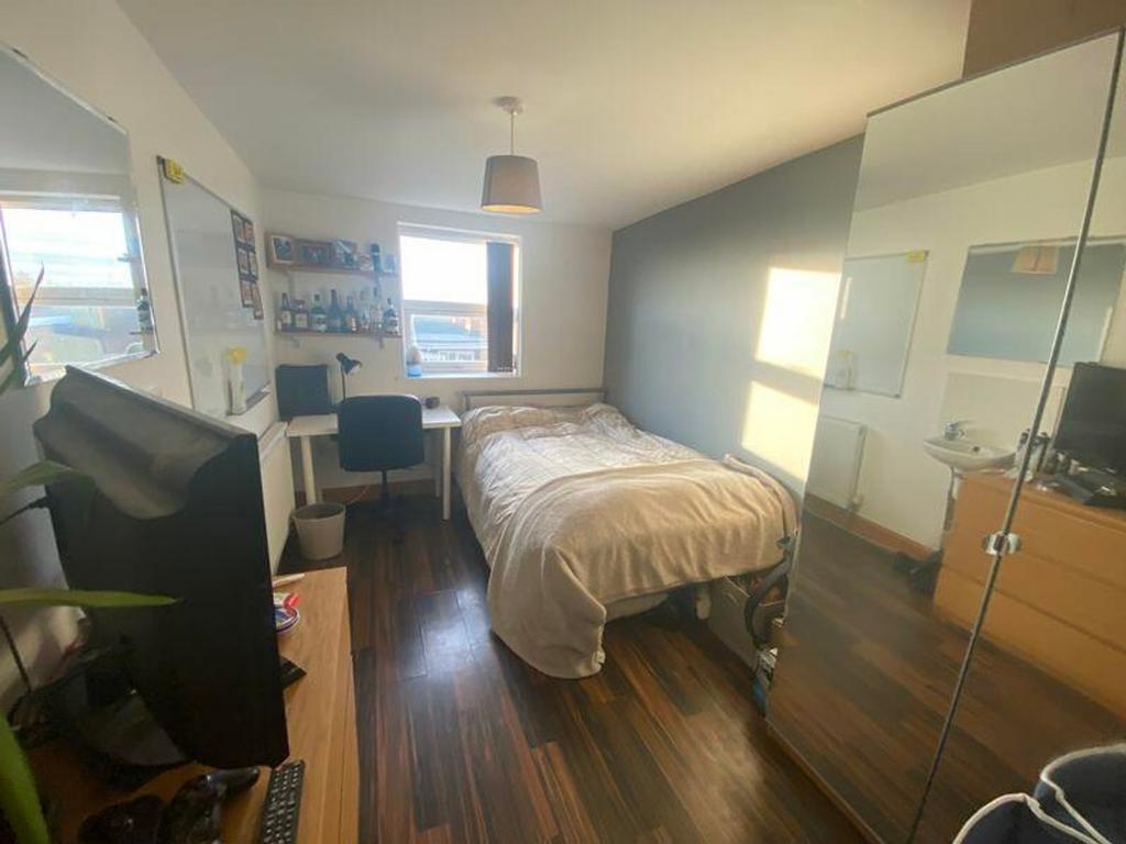 A bright and inviting double bedroom featuring ...