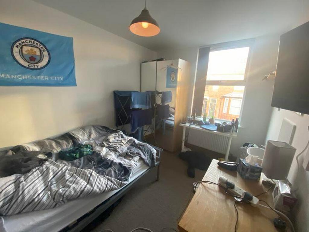 A cozy double bedroom with plenty of natural li...