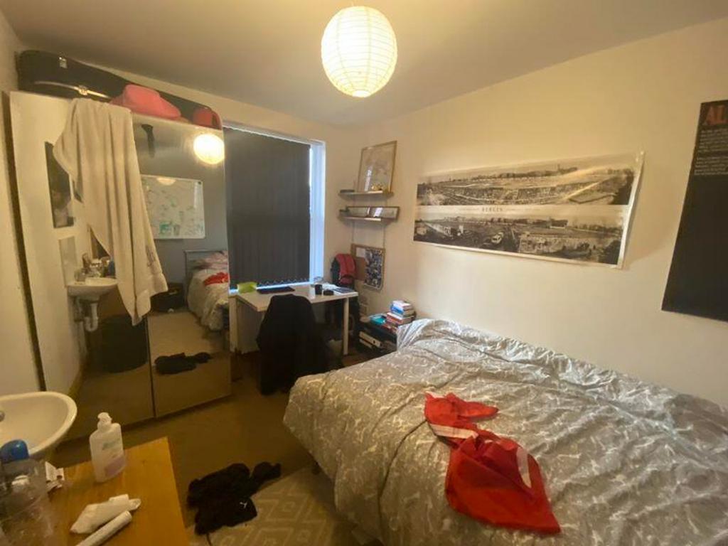 A cozy double bedroom with natural light and a ...