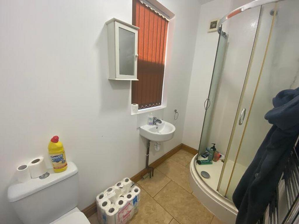 A tidy bathroom featuring a shower and ample st...