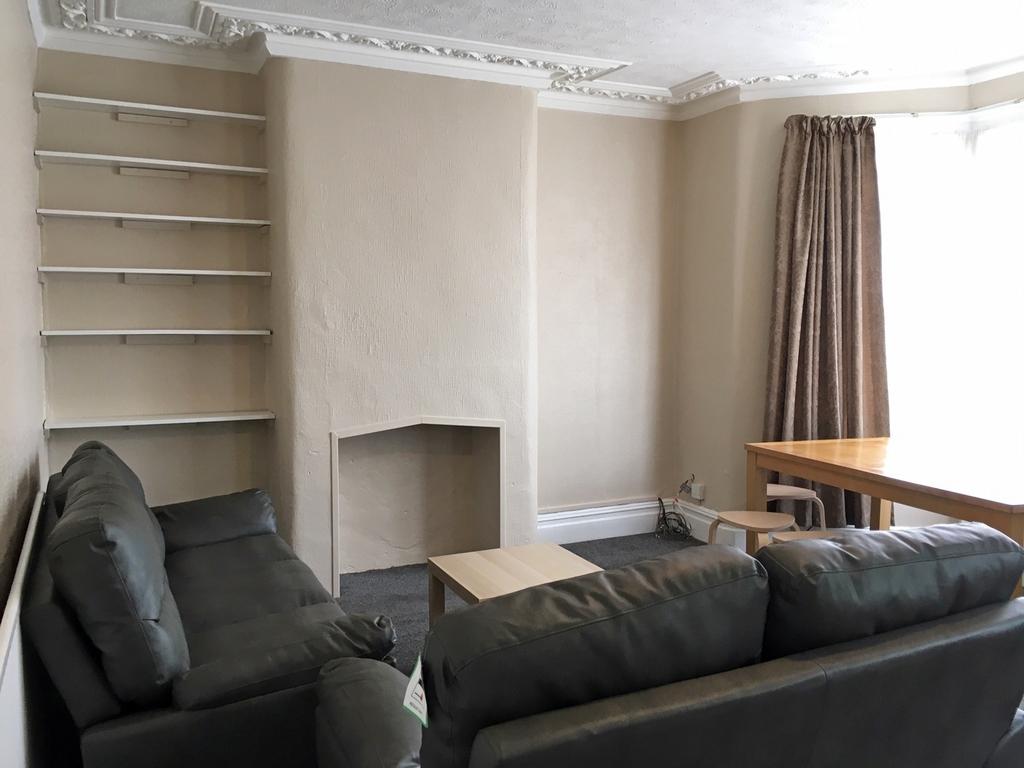 Spacious and inviting living room featuring com...