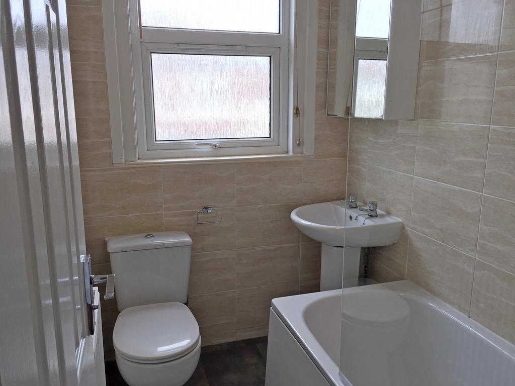 A well-maintained bathroom featuring a bath, si...