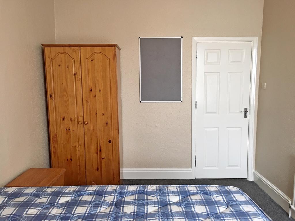Spacious double bedroom featuring a comfortable...