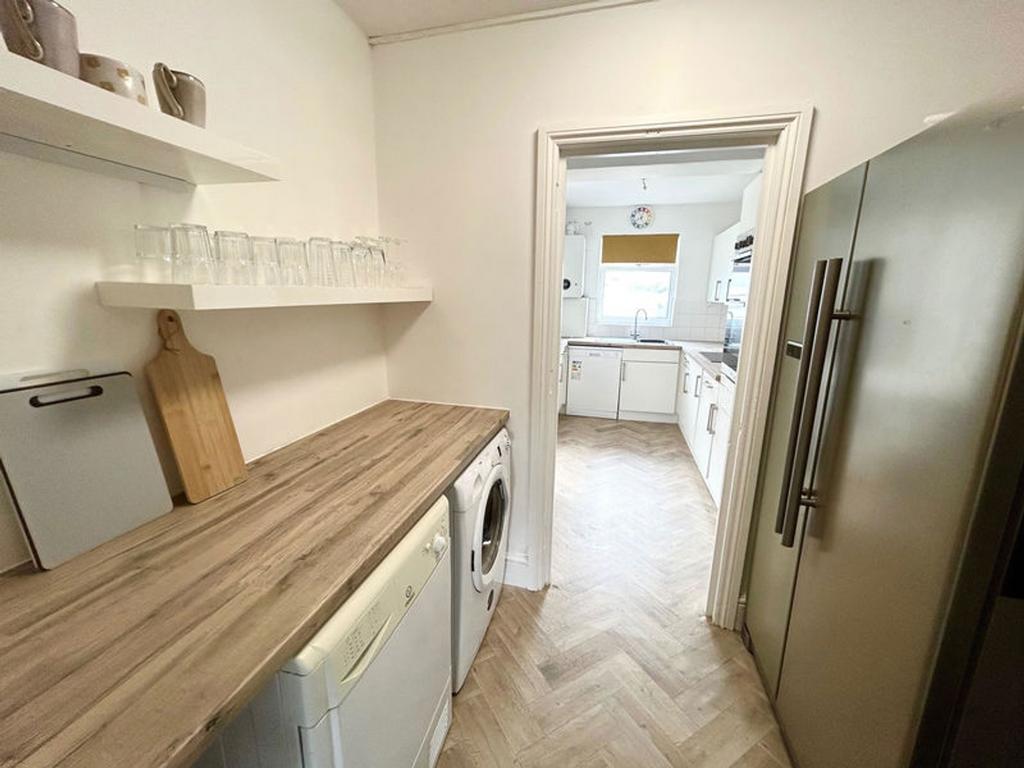 A modern kitchenette featuring a clean and tidy...