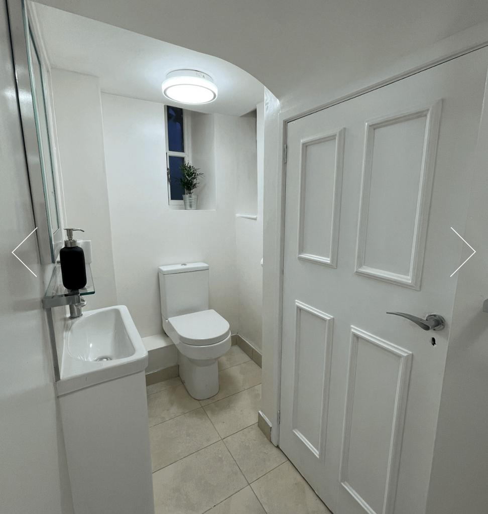 A bright and tidy single toilet with modern fix...