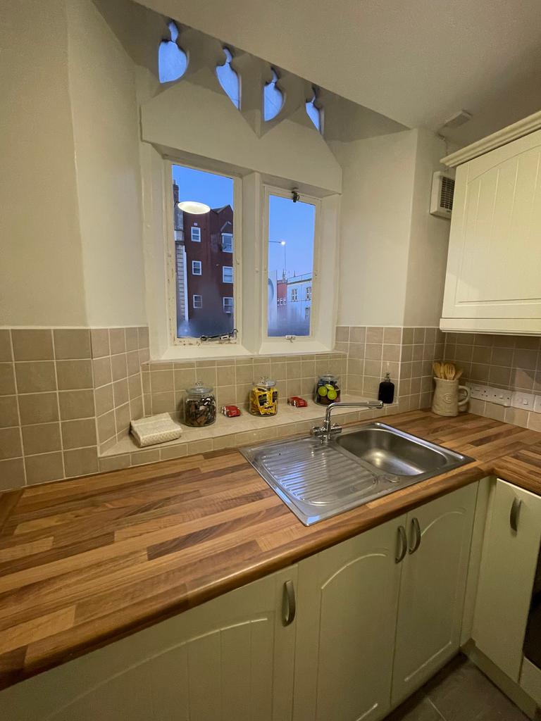 A charming kitchen featuring a well-maintained ...