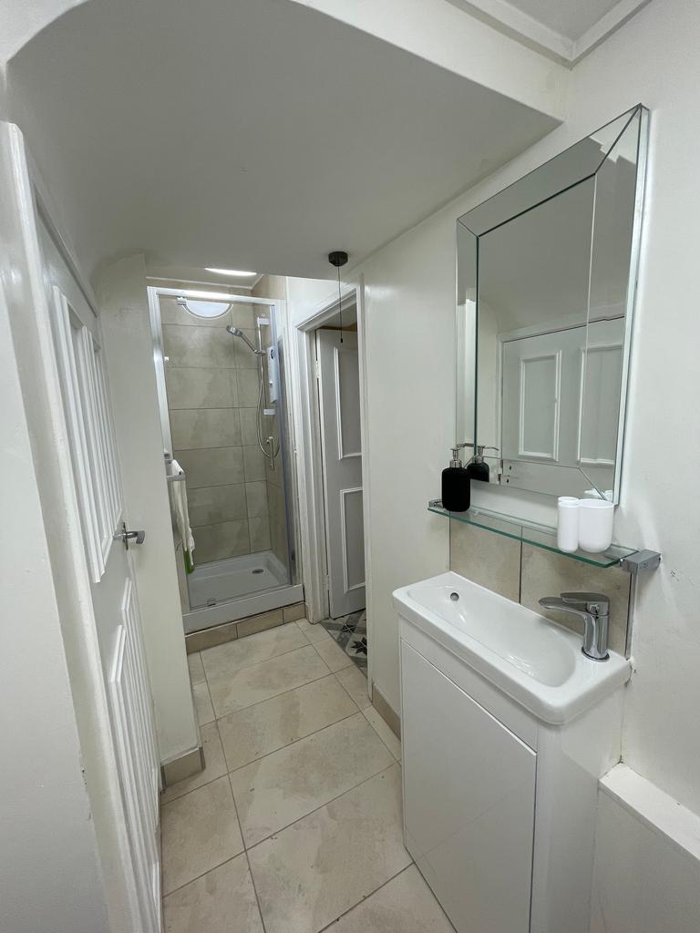 A modern bathroom featuring a sleek shower, sty...