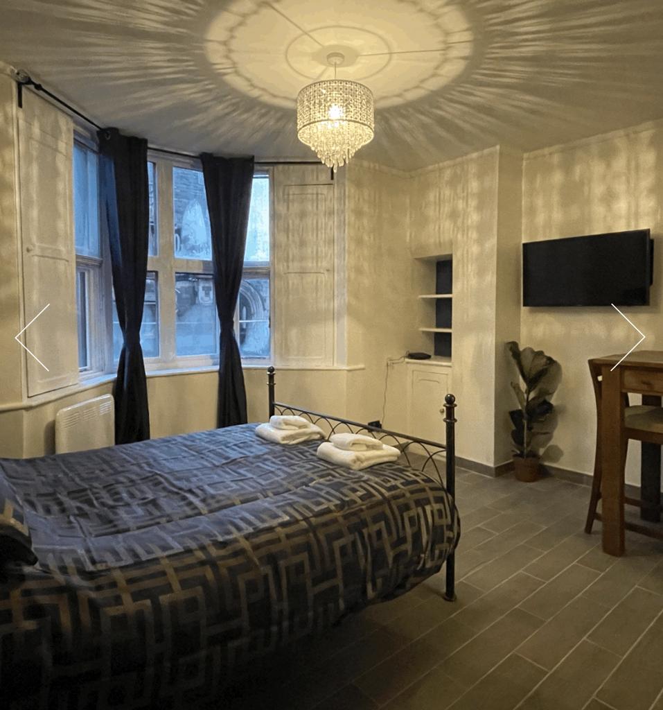 A stylish and well-lit double bedroom featuring...
