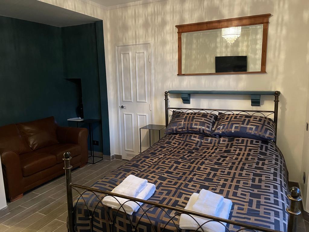 This stylish double bedroom features a comforta...