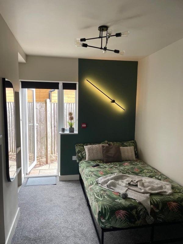 A bright and inviting single bedroom featuring ...