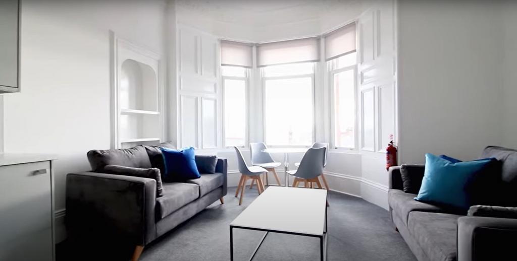 Bright and contemporary living room featuring a...