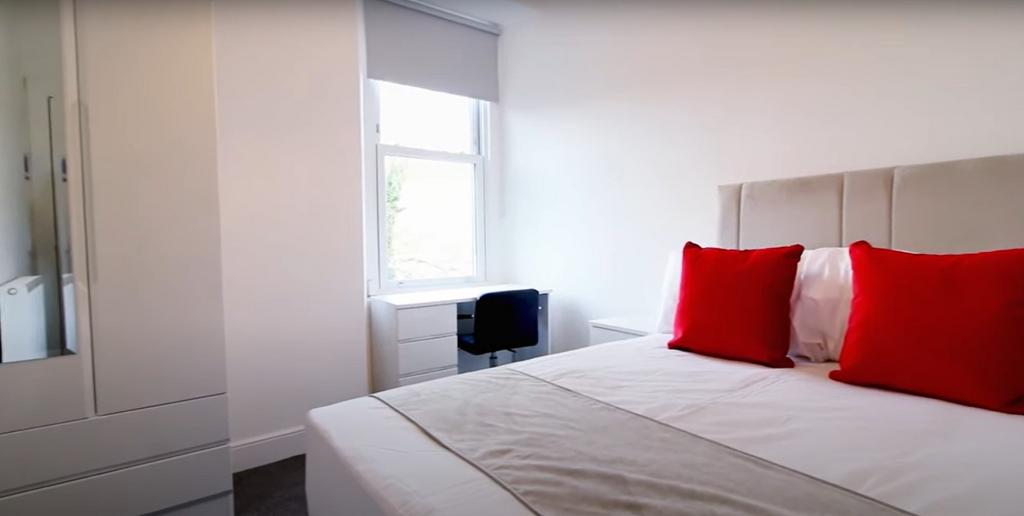 A bright and modern master bedroom featuring a ...