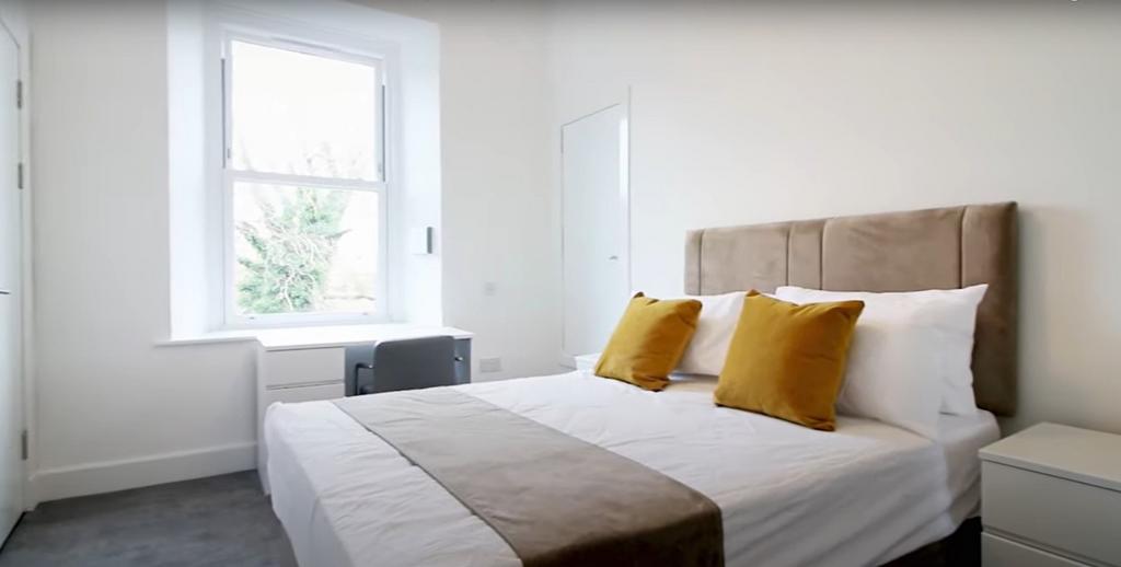 A bright and cozy double bedroom featuring a co...