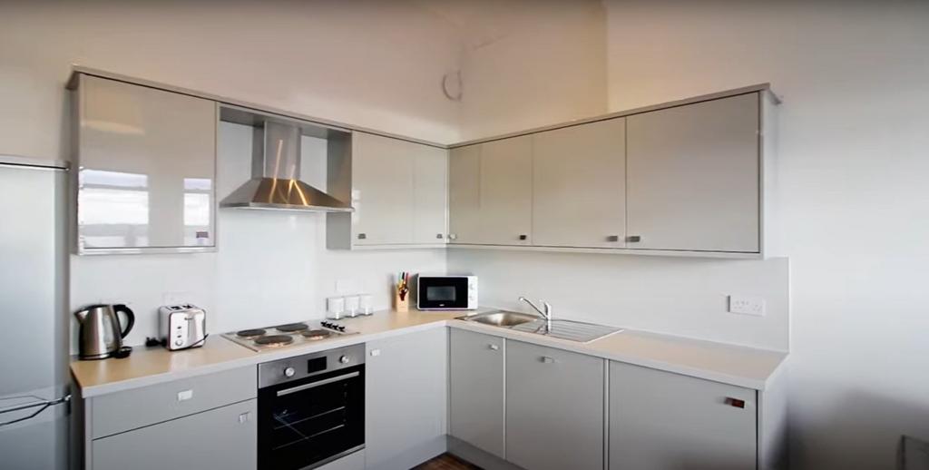 Bright and modern kitchen featuring sleek cabin...