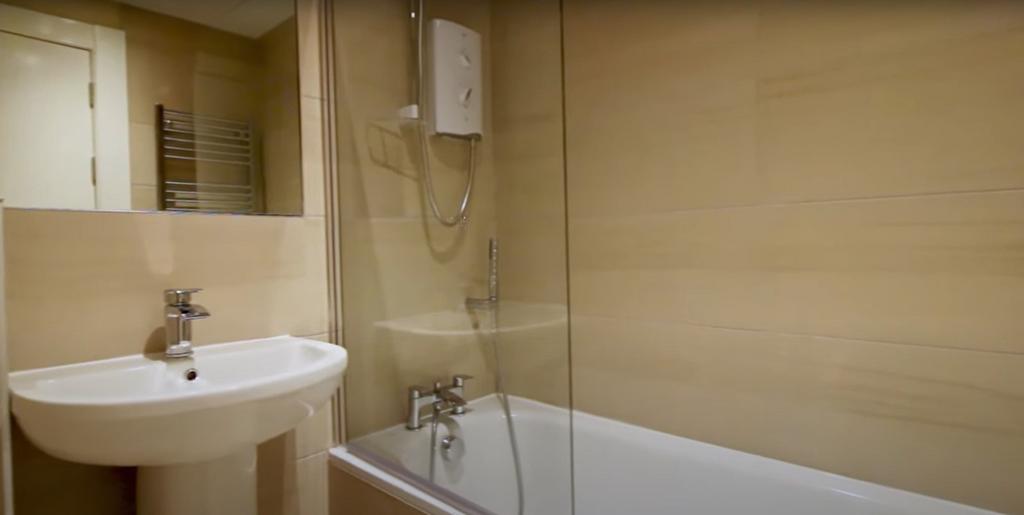 A clean and modern bathroom suite featuring a b...
