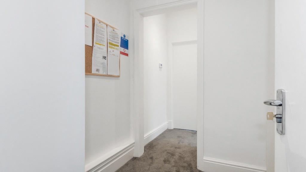 A bright and tidy hallway featuring a clean car...