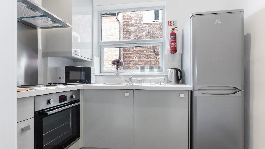 Modern kitchen featuring sleek appliances, ampl...