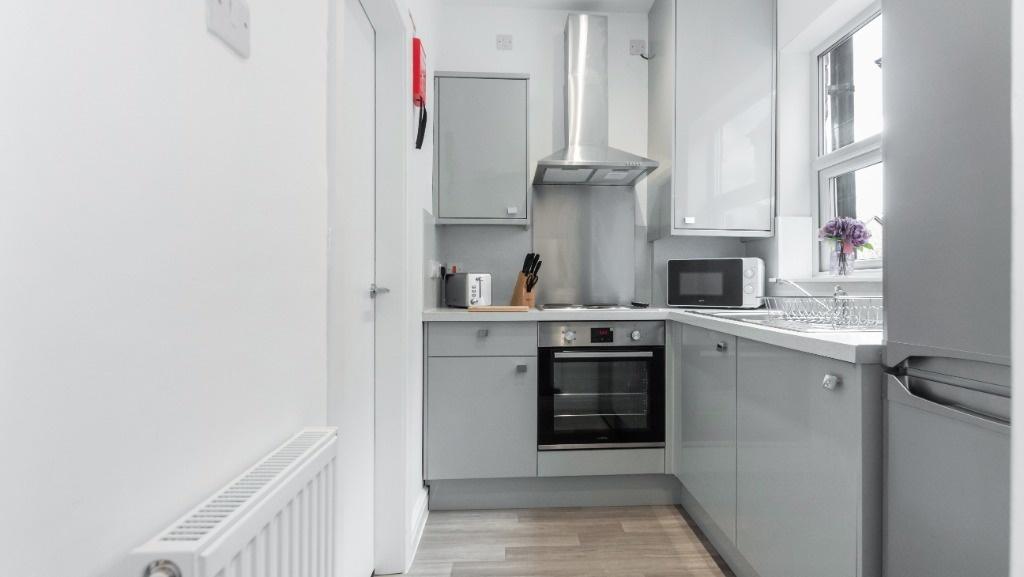 This modern kitchen features sleek cabinetry an...