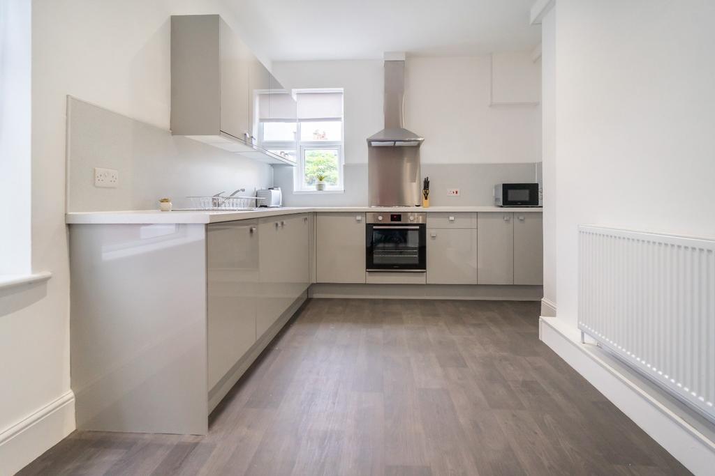 A modern kitchen featuring sleek cabinetry and ...