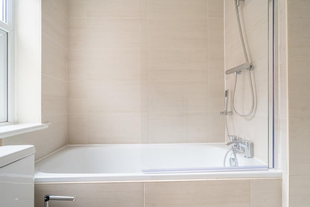 Experience a modern bathroom suite featuring a ...