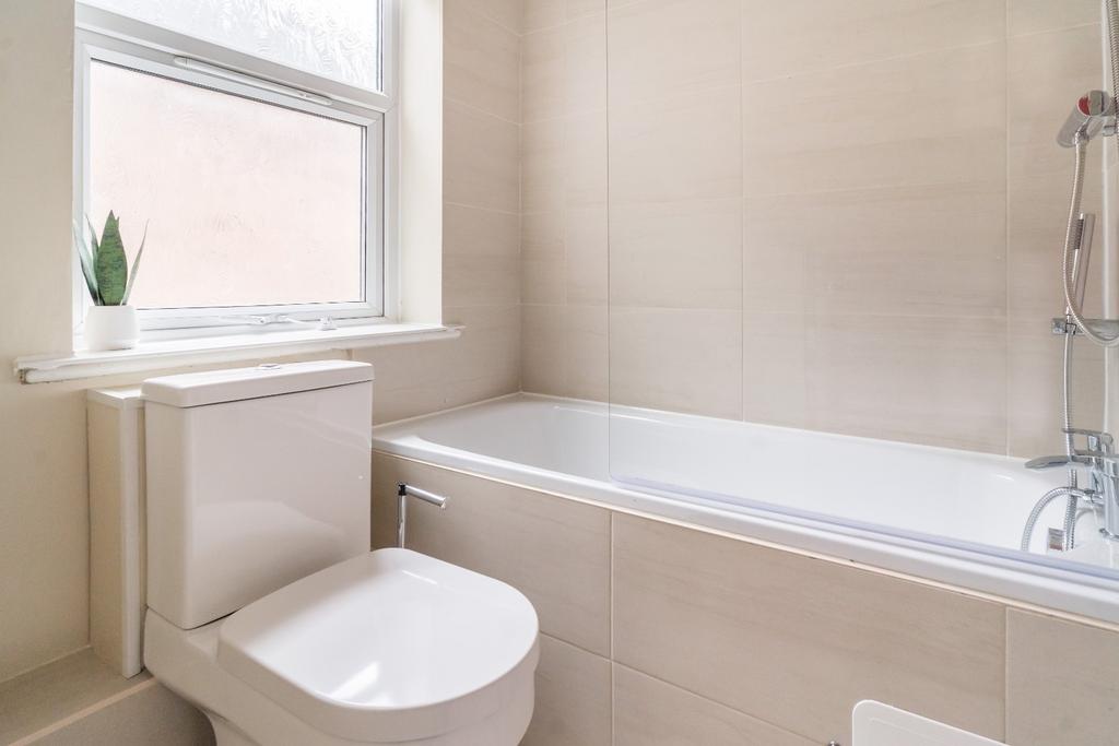 This modern bathroom features a sleek bathtub a...