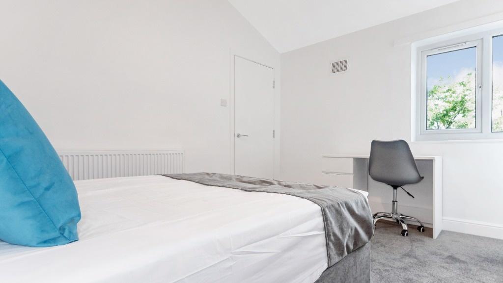 Bright and cozy double bedroom featuring a comf...