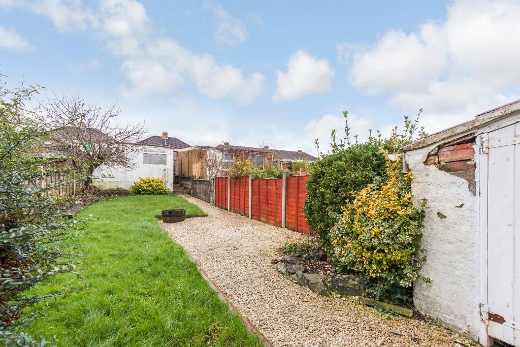 A well-maintained garden featuring a lush lawn,...