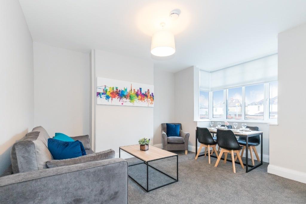 A bright and modern living room featuring a com...