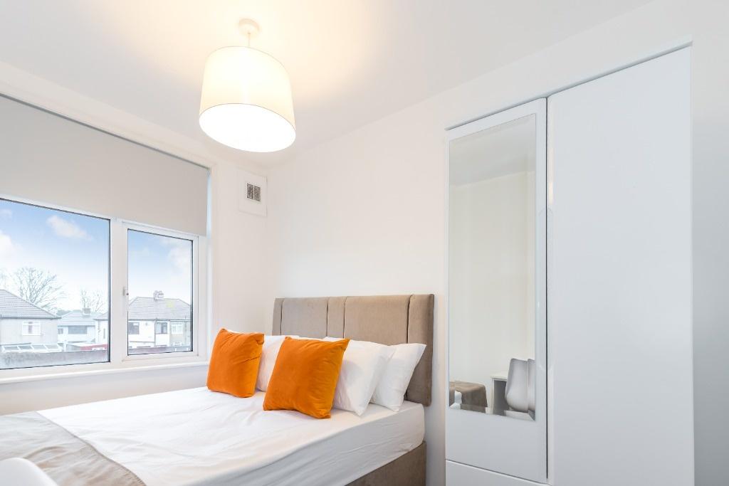 Bright and modern double bedroom featuring a co...