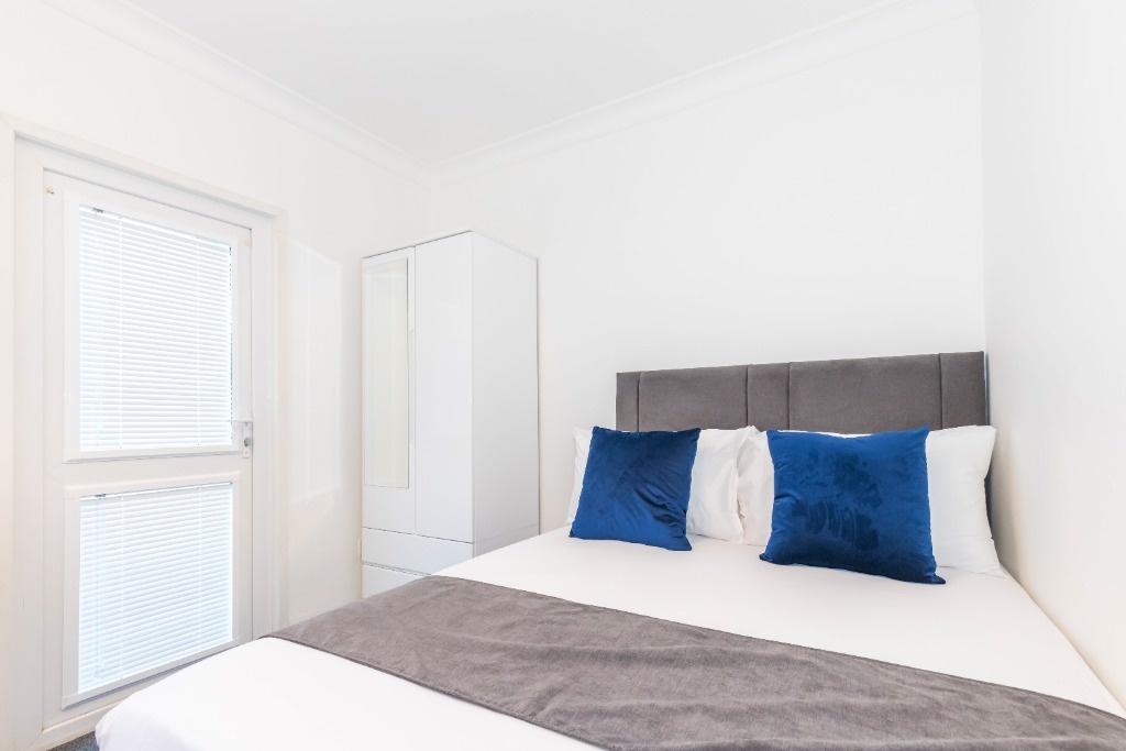 Bright and modern double bedroom featuring a co...
