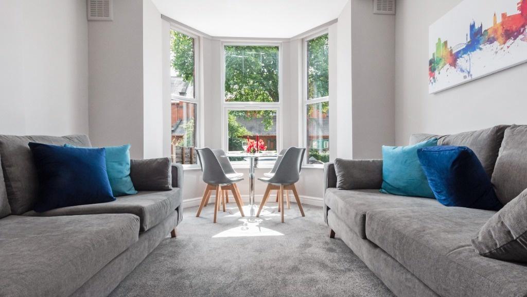 This inviting living room features ample natura...