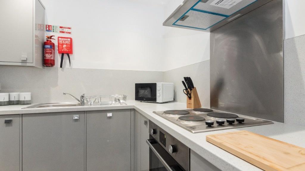 This modern kitchen features sleek cabinetry, a...