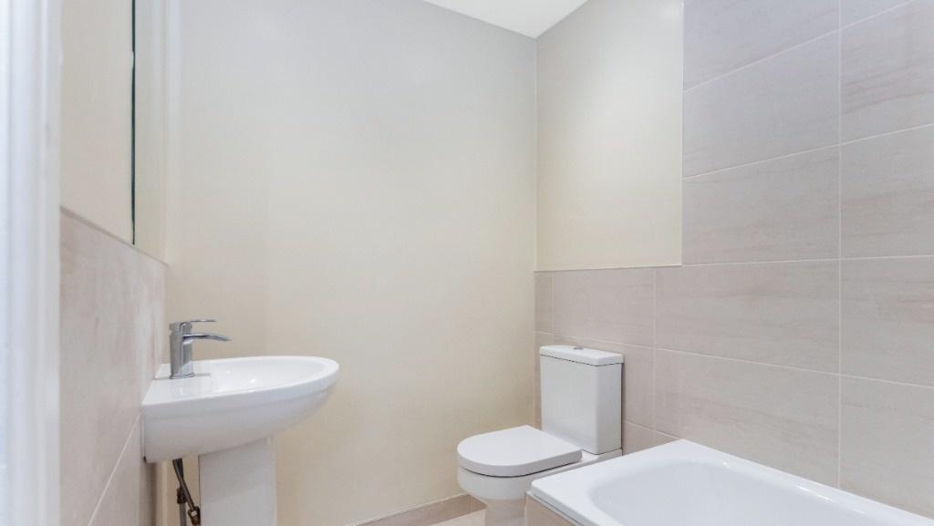 A modern bathroom featuring a clean design with...