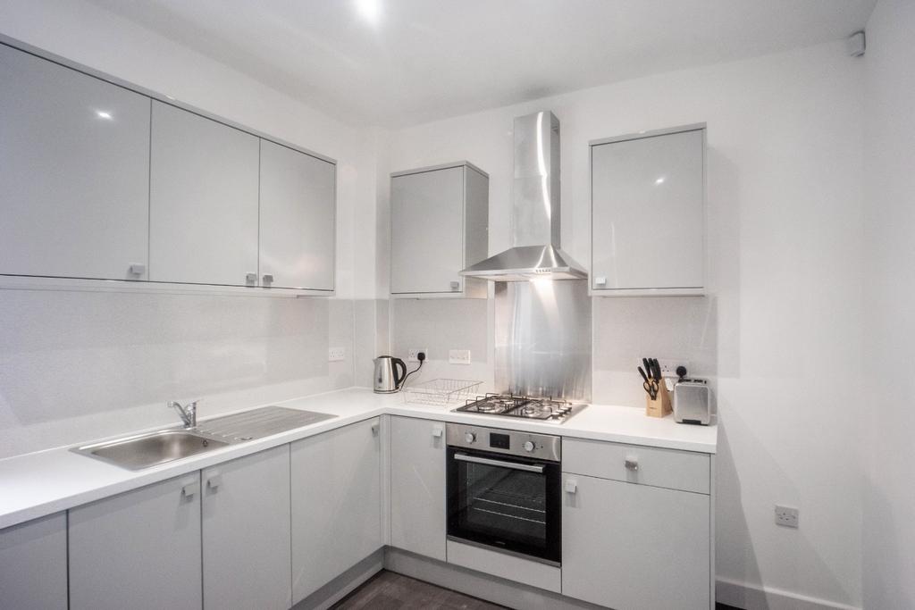 Modern kitchen equipped with sleek cabinetry an...