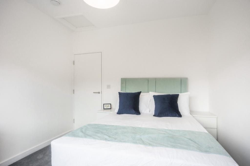 This inviting double bedroom features a comfort...