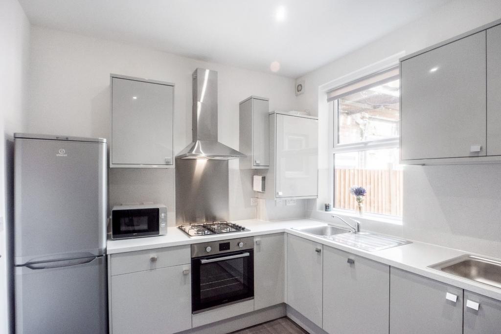 This modern kitchen features sleek cabinetry, s...