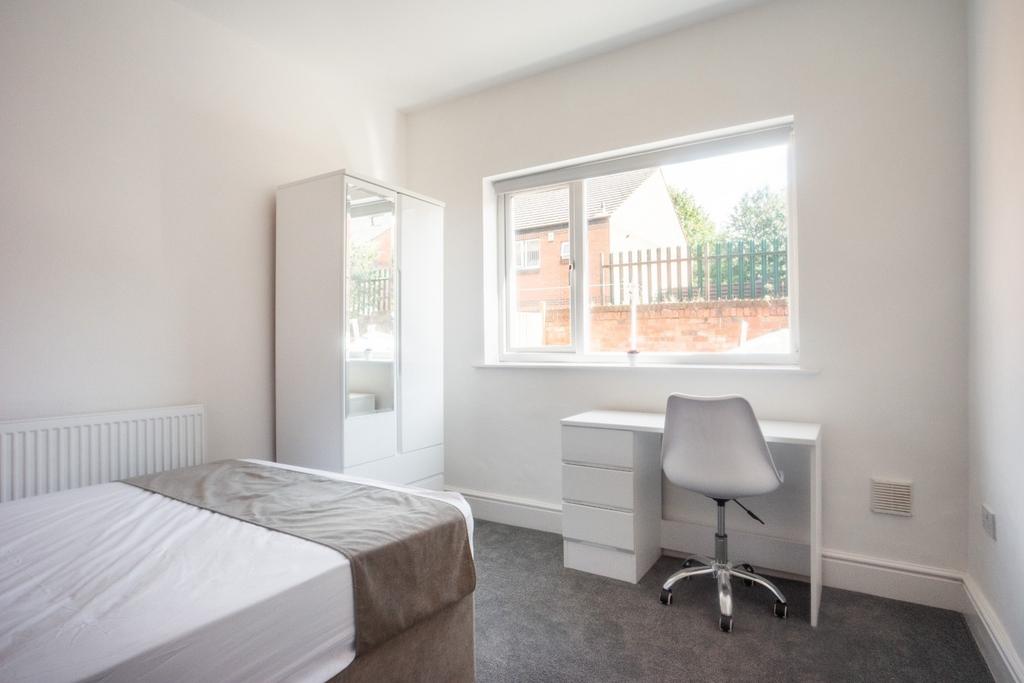 A bright and inviting double bedroom featuring ...