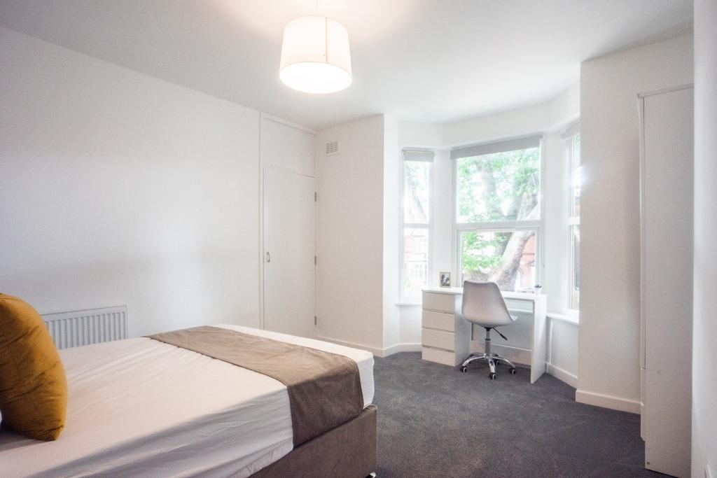 Bright and spacious double bedroom featuring la...