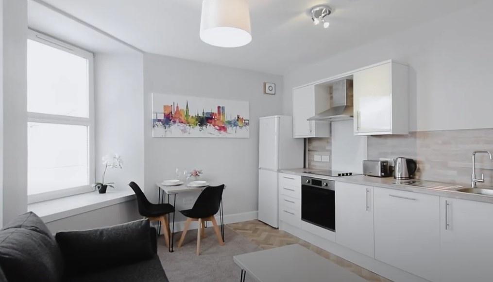 Bright and modern kitchen featuring sleek white...