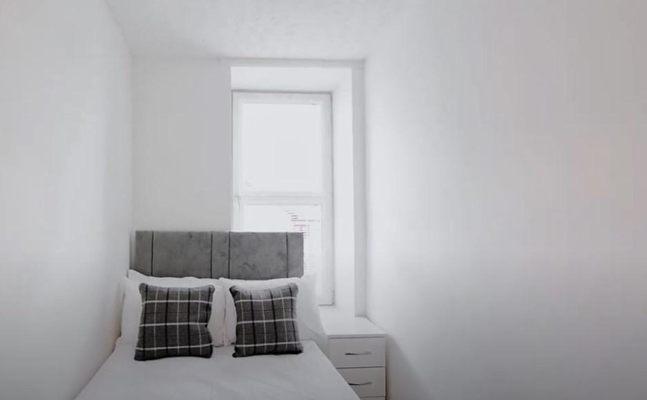 This cozy double bedroom features a comfortable...
