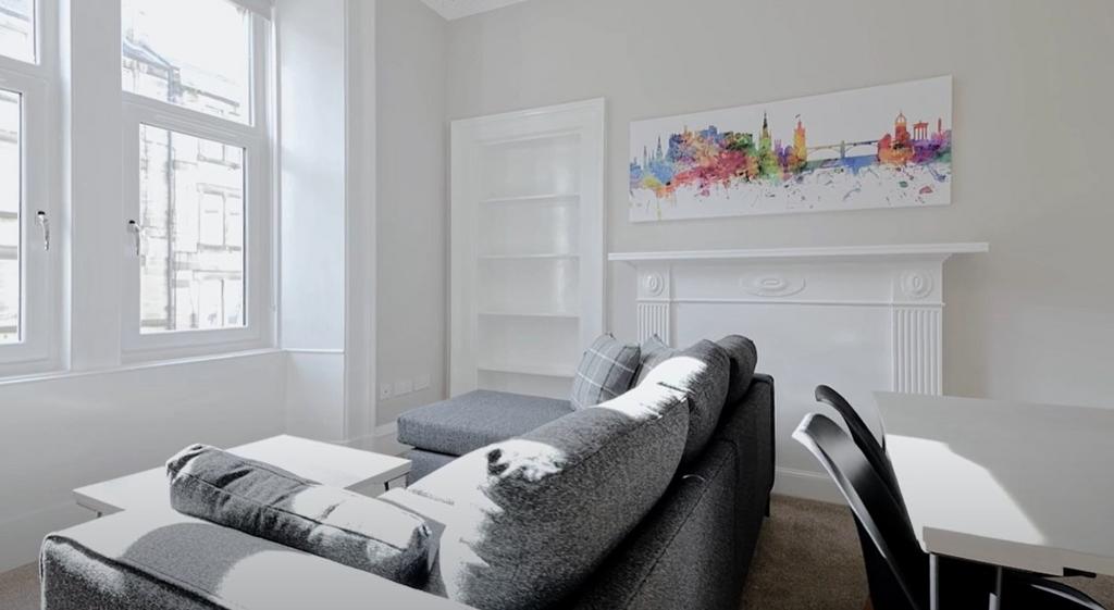 Bright and inviting living room featuring large...