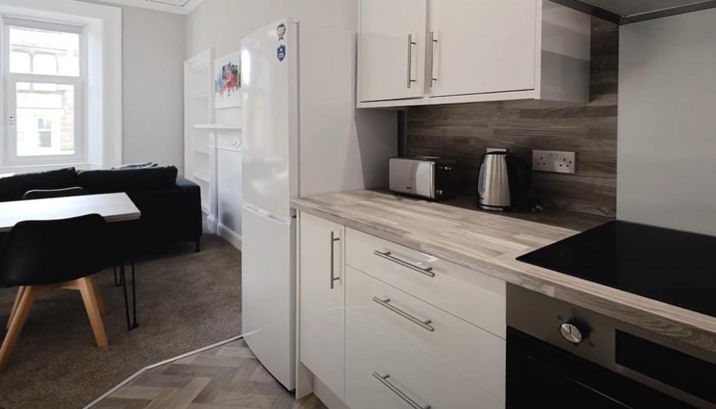 Modern kitchen featuring sleek cabinetry, ample...