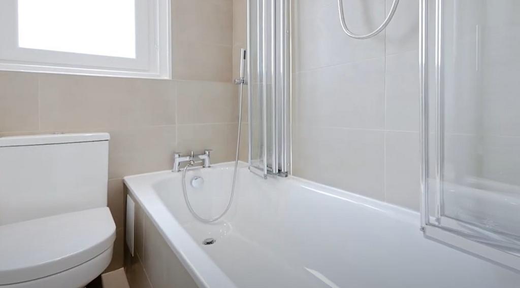 Bright and modern bathroom featuring a sleek de...