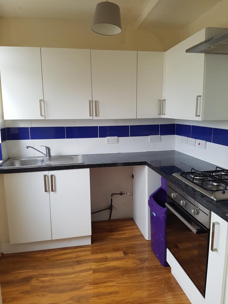 A modern and tidy kitchenette with ample storag...