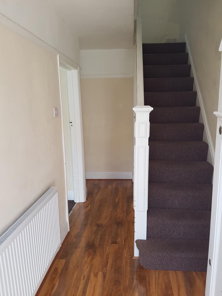 A tidy and well-maintained hallway featuring a ...