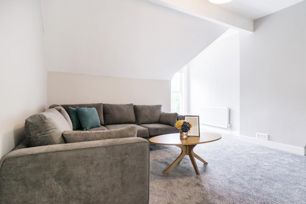 A contemporary living room featuring a cozy sec...