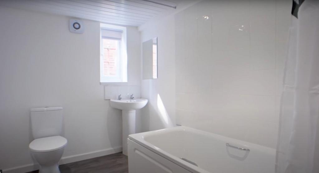 Bright and clean bathroom featuring a modern ba...