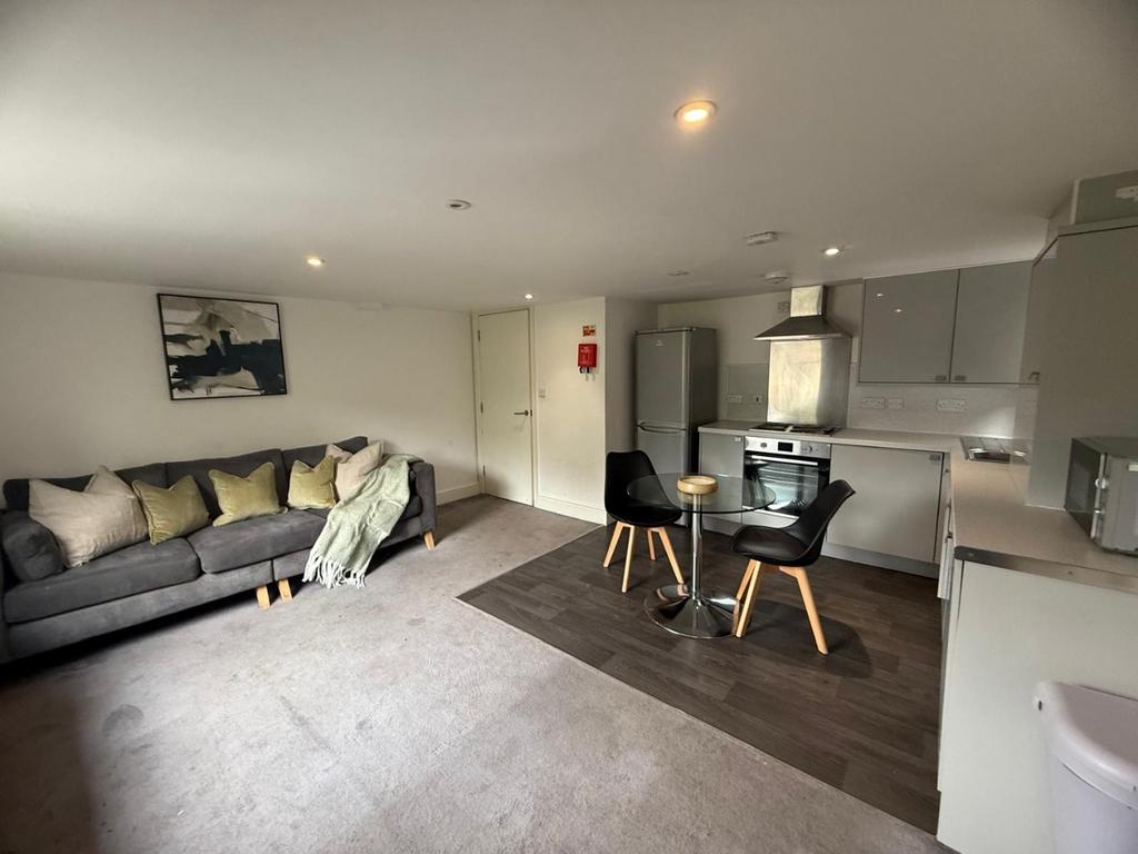 Open-plan lounge with sofa and dining area...