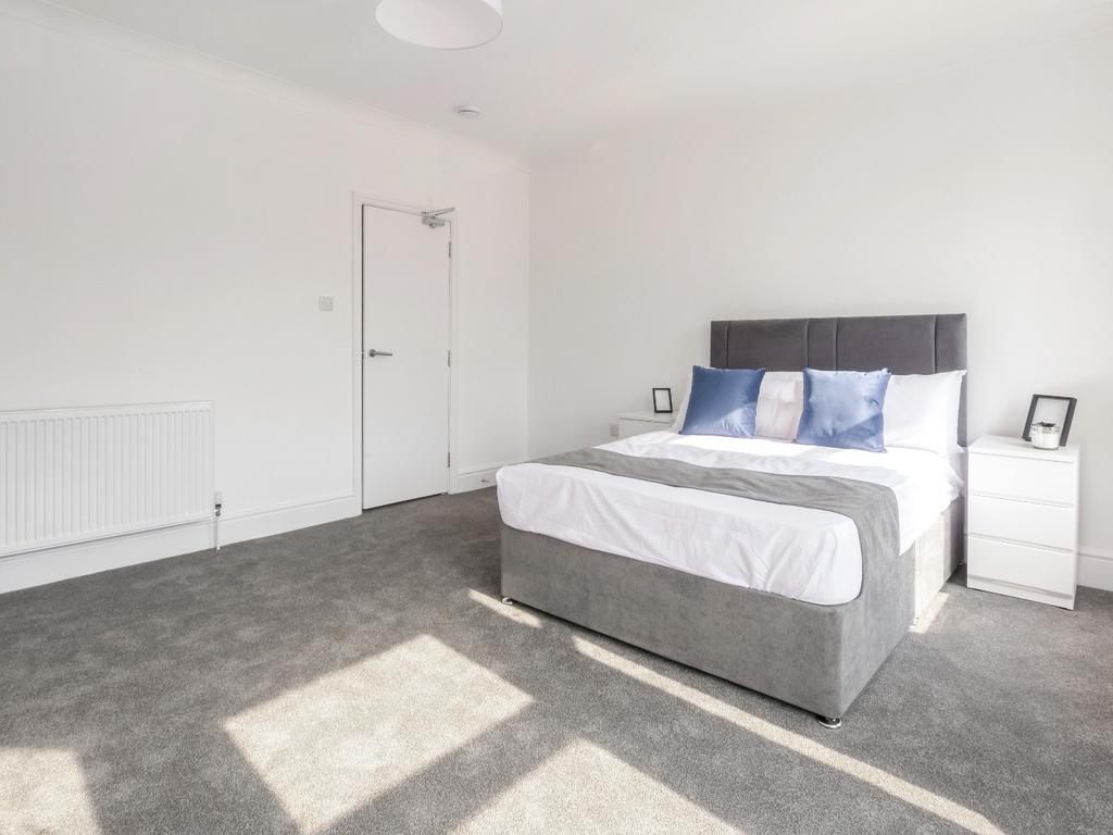 Bright and spacious master bedroom featuring a ...