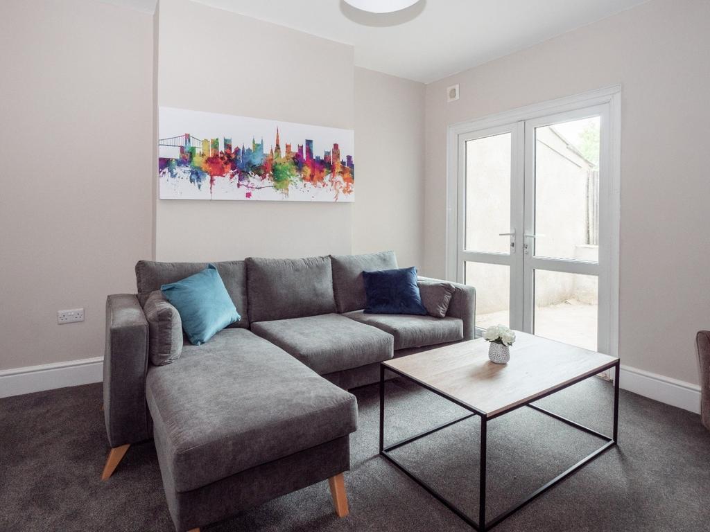 A cozy and modern living room featuring a comfo...
